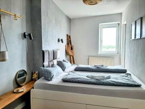 a bedroom with two beds and a window at Über den Dächern der Altstadt in Rostock