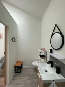 a white bathroom with a sink and a mirror at Maison d'hôtes 3 chambres/3 sdb - 3 à 6 personnes in Avanton