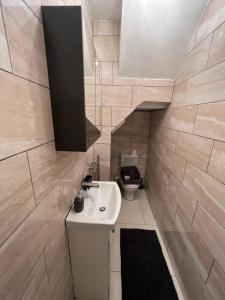 a bathroom with a sink and a toilet at Flat 3 Rylands Street in Warrington
