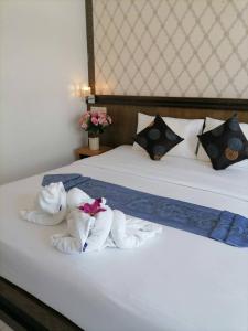 a hotel room with towels on a bed at NJ PATONG HOTEL in Patong Beach