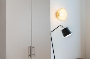 a floor lamp next to a white wall at easy flat Sankt Elisabeth in Vienna