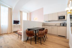 a kitchen and dining room with a table and chairs at easy flat Sankt Elisabeth in Vienna