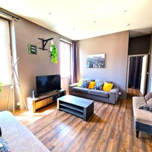 a living room with two couches and a flat screen tv at Le Central Parc - T2-Spacieux-Clim-Wifi in Marseille