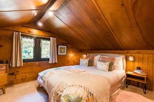 a bedroom with a large bed in a wooden room at Le Petit Rêve - Lac de Montriond in Montriond