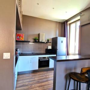 a kitchen with white appliances and a counter top at Le Central Parc - T2-Spacieux-Clim-Wifi in Marseille