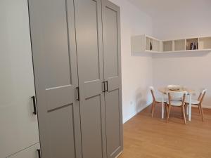 a white cabinet in a room with a table at Slaska 12 in Gdańsk