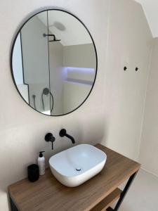 a bathroom with a white sink and a mirror at Zadar Penthouse in Zadar