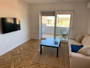 a living room with a couch and a table at Zadar Penthouse in Zadar