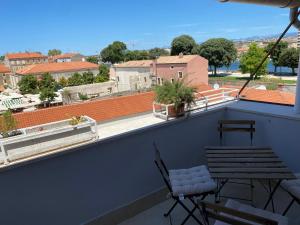 a balcony with chairs and a view of a city at Zadar Penthouse in Zadar