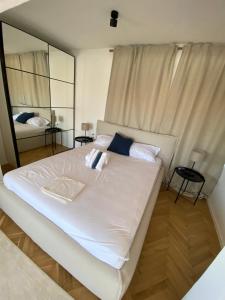 a large white bed in a room with a mirror at Zadar Penthouse in Zadar