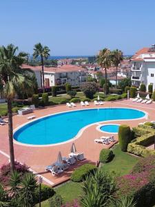 a large swimming pool with lounge chairs and umbrellas at Ferienwohnung in Side Türkei in Side