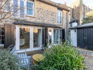 an extension to a brick house with sliding glass doors at The Coach House - Unique split level property in Kent