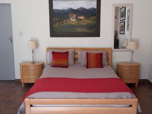 a bedroom with a large bed with two night stands at Lemberg Wine Estate in Tulbagh