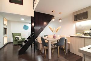 a kitchen and dining room with a table and chairs at Budapest Downtown Museum Apartments in Budapest