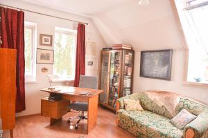 a living room with a couch and a desk at Sirbi House in Tallinn