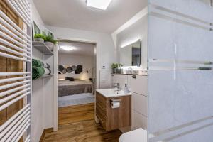 a bathroom with a sink and a bed in a room at La 12 in Bad Urach