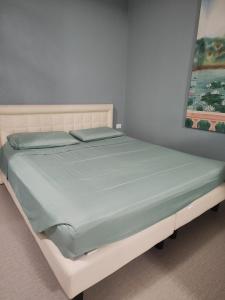 un letto in una stanza con un dipinto sul muro di Attico Open Space - Piscina a 400 mt a Desenzano del Garda