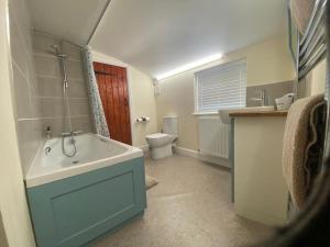 a bathroom with a sink and a toilet in it at Skippings in Beccles