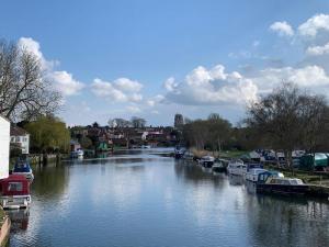 a river with boats parked on the side of it at Skippings in Beccles