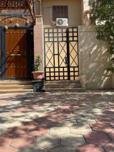 a gate in front of a house with a door at New Cairo COZY Studio 2 bedrooms & 2 bathrooms in Cairo