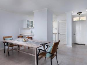 a kitchen and dining room with a table and chairs at Zenbreak Vuemont 245 in Saint Peter