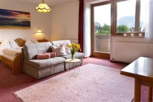 a living room with a couch and a table at Haus Almrose in Leutasch +33 photos