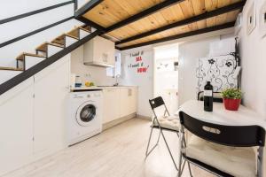a kitchen with a table and chairs in a room at Studio 4 Puerta Del Sol in Madrid