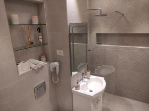 a bathroom with a white sink and a shower at Aparthotel Black Sea in Constanţa +15 photos