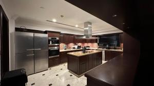 a large kitchen with a stainless steel refrigerator at Neyar Beach Vibes in Dubai