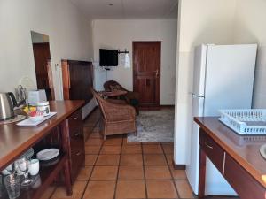 a kitchen with a white refrigerator in a room at Aant Dorpseind in Vanrhynsdorp