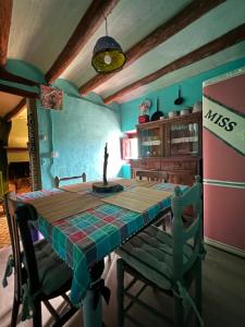 een keuken met een tafel en een tafel en een koelkast bij Ca la Traviesa - Refugio del Arte - Pet Lovers - Adults Only - Montsant in Bellaguarda