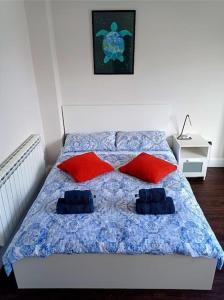 a bedroom with a bed with two pillows on it at Ovidio's House - Peaceful flat with Terrace Relax in London