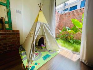 a teepee tent sitting on the floor in a room at INS White House Ipoh in Ipoh