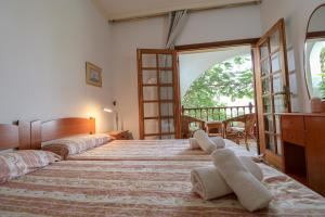 a bedroom with a large bed with pillows on it at Lovely house views&garden in Agaete