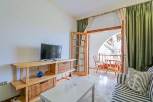 a living room with a tv and a couch at Lovely house views&garden in Agaete