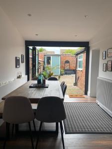 una sala da pranzo con tavolo e sedie in legno di Luxury Spacious Renovated Townhouse a Grantham