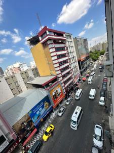 a busy city street with cars parked in front of a building at GRAND CLOVER otel in Seyhan