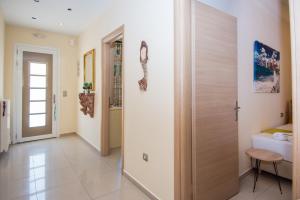 a hallway with a door leading to a bedroom at Sofia's Delightful Apartment in Argostoli