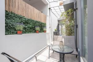 a balcony with a table and some plants at Artistic spacious home at Gazi in Athens