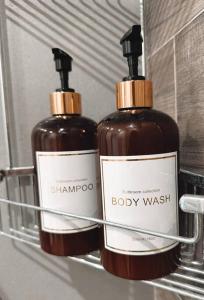 two bottles of soap sitting on a shelf at Charmant duplex proche Paris in Saint-Maurice