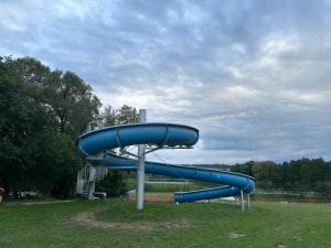 a blue water slide in a park at Jarkowy domek in Baranowo