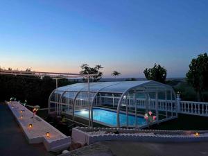 a large glass house with a pool in it at Casa La Vanidosa in Barajas de Melo