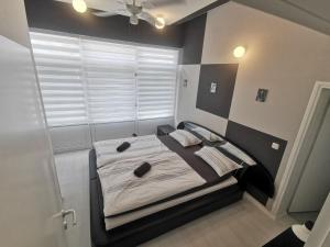 a bedroom with a bed with a black headboard at Apartman Marija in Livno