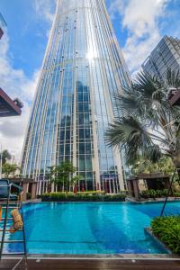 a tall building with a pool in front of it at Hyatt Regency Shenzhen Yantian in Shenzhen