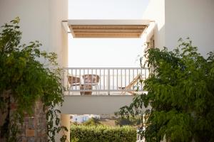 a balcony with a table and chairs on it at Summer Senses Luxury Resort in Logaras