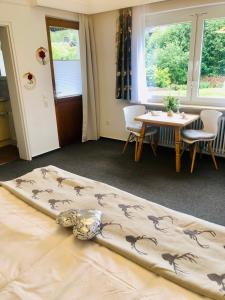 a bed in a room with a table and chairs at Haus Anna-Marie in Feldberg