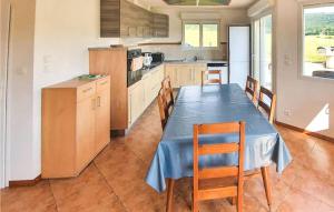 a kitchen with a blue table and chairs in it at Stunning Home In Ouhans With Wifi And 3 Bedrooms in Ouhans