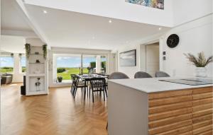 a kitchen and dining room with a table and chairs at 4 Bedroom Nice Home In Slagelse in Slagelse