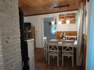 a kitchen and dining room with a table and chairs at Triglav Cottage in Bohinj