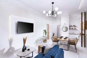 a living room with a blue couch and a table at Arbona Apartment Ι in Vóroi